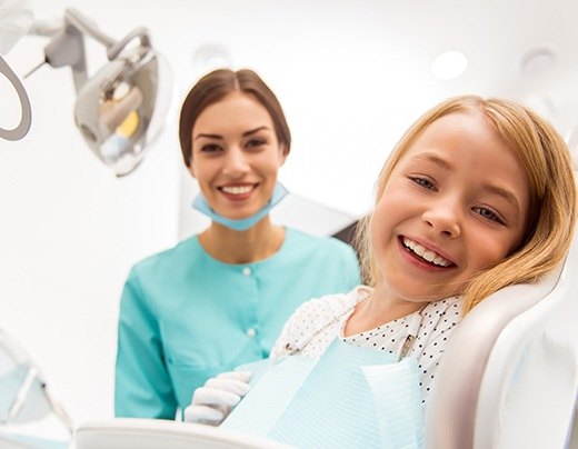 Young girl laughing during dental checkup