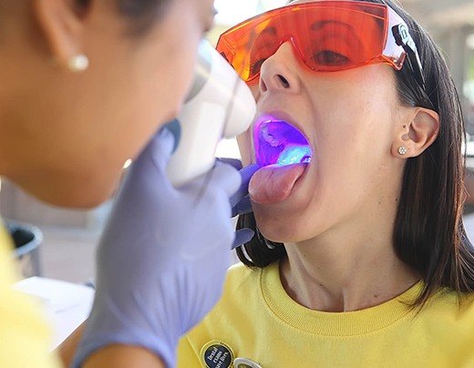 Woman receiving oral cancer screening