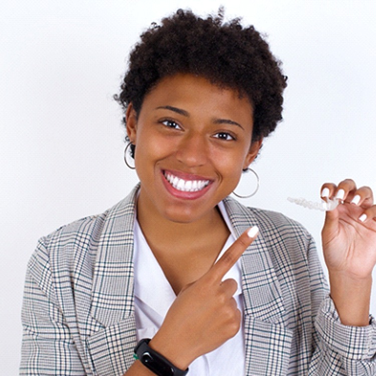 woman holding a clear aligner in Boerne