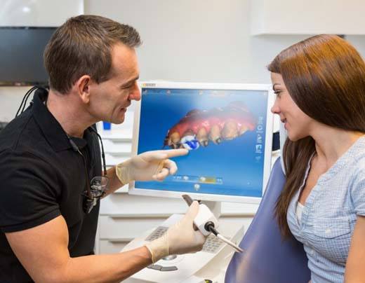 model of a dental crown being placed over a tooth