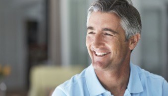 Man with attractive smile after replacing missing teeth