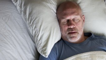 Man sleeping soundly thanks to sleep apnea therapy