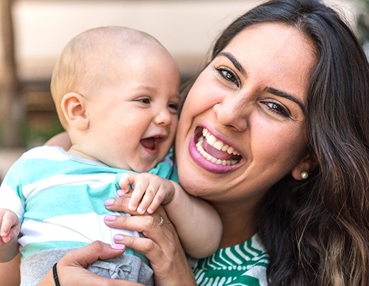 Laughing mother and baby after frenectomy