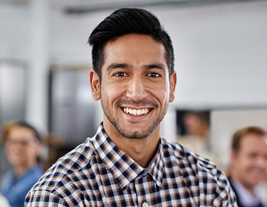 Man with flawless smile after metal-free dental crown placement