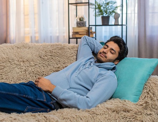 Man napping on his softa at home