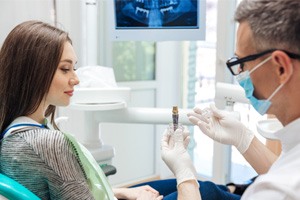 a dentist explaining how dental implants work in Boerne