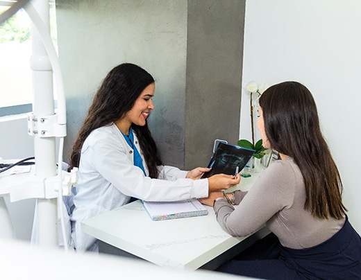 Dentist discussing the cost of a root canal treatment in Boerne