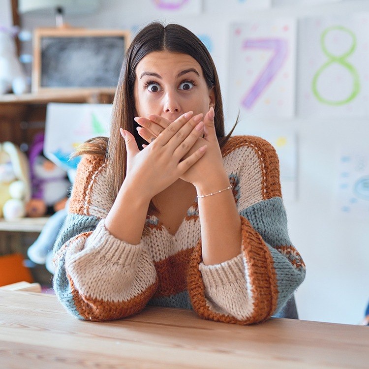 Fearful woman covering face in need of sedation dentistry