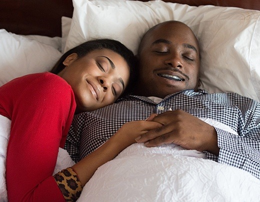 Man and woman sleeping soundly thanks to sleep apnea oral appliance therapy