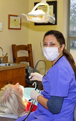 Dental team member treating dentistry patient