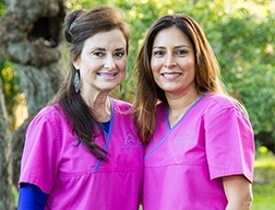 Two dental team members smiling