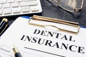 Clipboard holding dental insurance paperwork