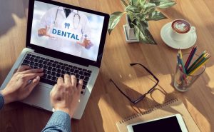 Man using computer to learn about dental insurance