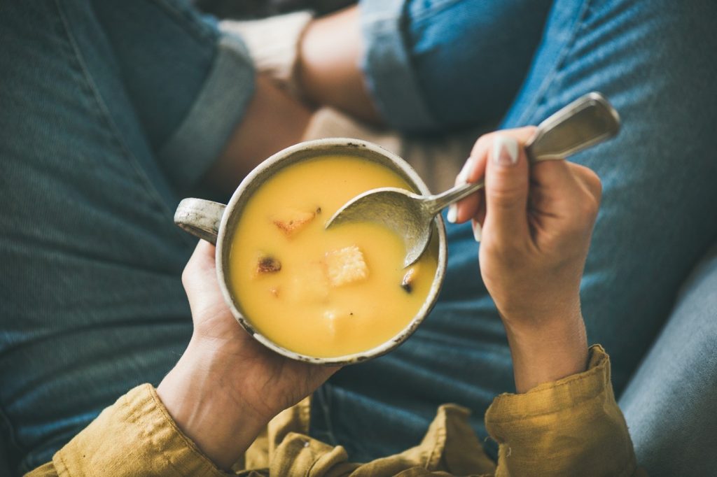 Woman enjoying vegetable soup