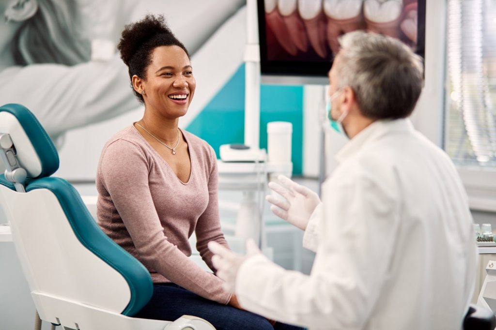 Dentist explaining to patient what happens after getting a dental crown